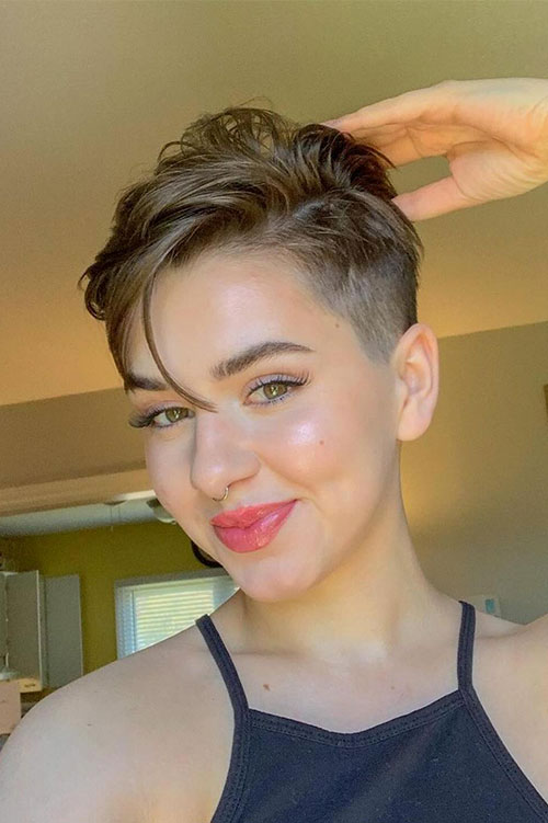 Edgy brunette pixie cut with buzz cut and blonde highlights