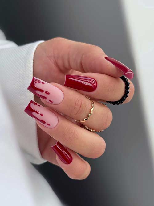 Dark red Halloween nails with blood drip on two accent diagonal French tip nails.