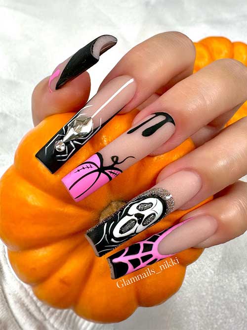 Long French black and pink Halloween nails with a rhinestone spider, glitter, scary ghost face, and black drip nail art!