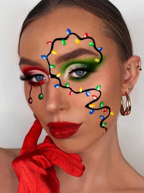 Red and green Christmas makeup look with glossy red lips and a creative Christmas lights makeup pattern