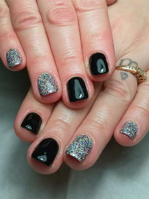 Short and simple New Year’s nails feature black and silver glitter nails