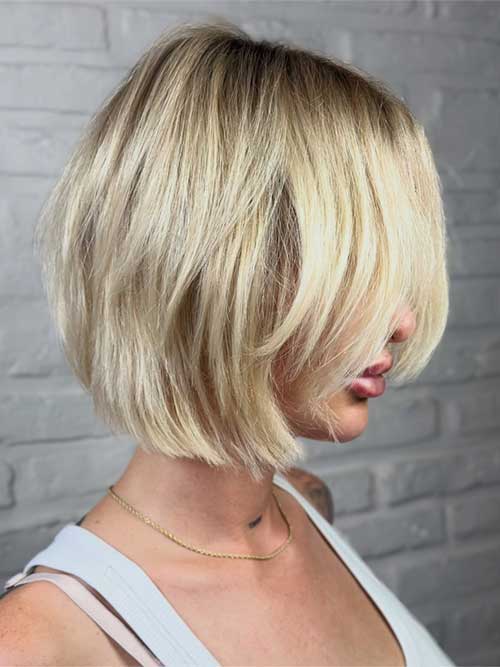 Elegant blonde bob with soft layers framing the face, radiating charm and sophistication for a modern, feminine look. Elegant blonde bob with soft layers framing the face, radiating charm and sophistication for a modern, feminine look.