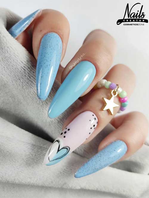 Glossy pastel blue design with speckled accents, heart detail, almond shape, and a beaded ring with a gold star charm. Glossy pastel blue design with speckled accents, heart detail, almond shape, and a beaded ring with a gold star charm.