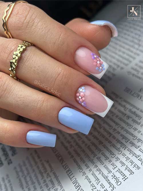Light blue nails with white French tips and tiny pink, purple, and blue flowers, creating an elegant and whimsical look. Light blue nails with white French tips and tiny pink, purple, and blue flowers, creating an elegant and whimsical look.