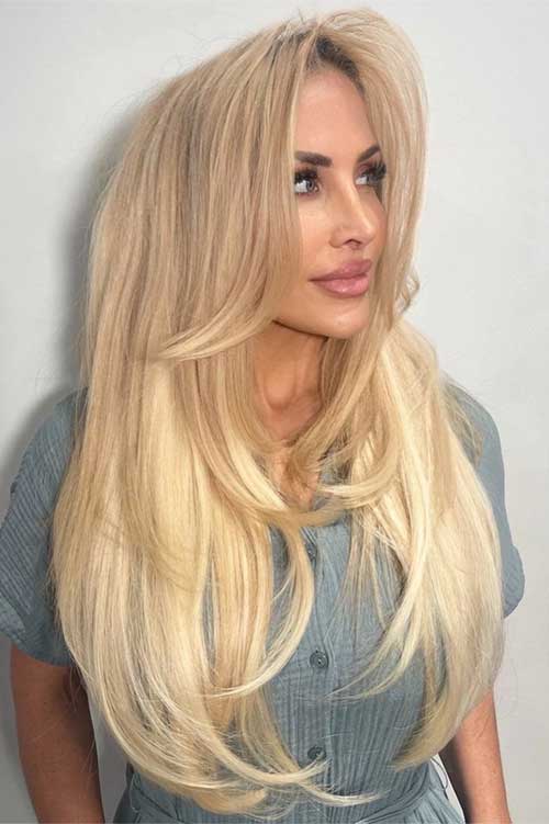 Close-up of a voluminous blowout hairstyle, highlighting soft, flowing layers and a glamorous, sophisticated look. Close-up of a voluminous blowout hairstyle, highlighting soft, flowing layers and a glamorous, sophisticated look.