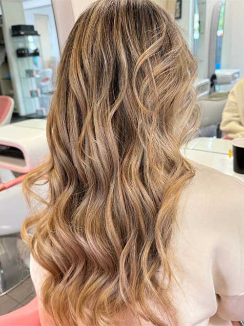 Effortlessly radiant blonde hair in beachy waves, showcasing a fresh, sun-kissed look ideal for summer outings and relaxation. Effortlessly radiant blonde hair in beachy waves, showcasing a fresh, sun-kissed look ideal for summer outings and relaxation.