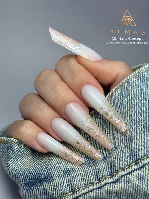 Elegant white nails fade into shimmering silver and gold glitter tips, perfect for any occasion, radiating quiet confidence. Elegant white nails fade into shimmering silver and gold glitter tips, perfect for any occasion, radiating quiet confidence.