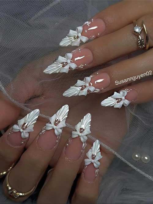 Elegant white nails with 3D seashells, white ties, and tiny rhinestones for a whimsical beachside French manicure. Elegant white nails with 3D seashells, white ties, and tiny rhinestones for a whimsical beachside French manicure.