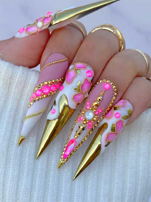 Milky gel stiletto nails with pink florals, golden tips, glitter, and rhinestones, perfect for glamorous events. Milky gel stiletto nails with pink florals, golden tips, glitter, and rhinestones, perfect for glamorous events.