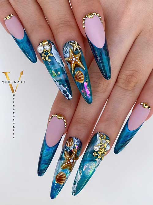 Stiletto ocean nails featuring a marbled aqua-blue base, nude pink tips, and 3D accents of starfish, seashells, and pearls. Stiletto ocean nails featuring a marbled aqua-blue base, nude pink tips, and 3D accents of starfish, seashells, and pearls.