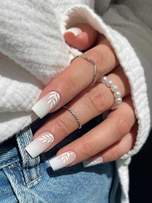 Timeless Babyboomer nails featuring a smooth nude-to-white gradient and white leaf accents, ideal for work or dinner. Timeless Babyboomer nails featuring a smooth nude-to-white gradient and white leaf accents, ideal for work or dinner.